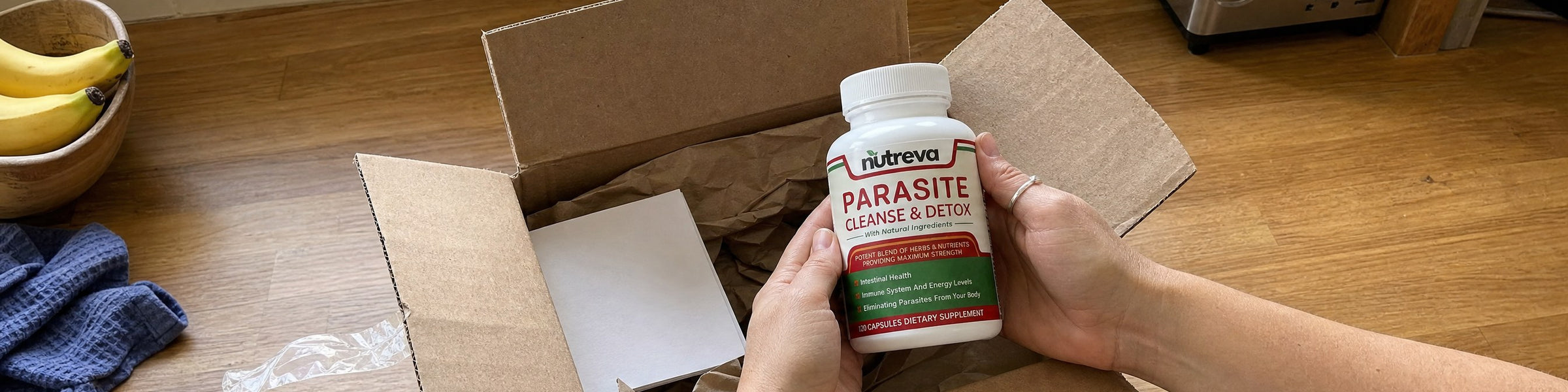 Unmarked shipping box open on a kitchen counter, bottle being lifted out
